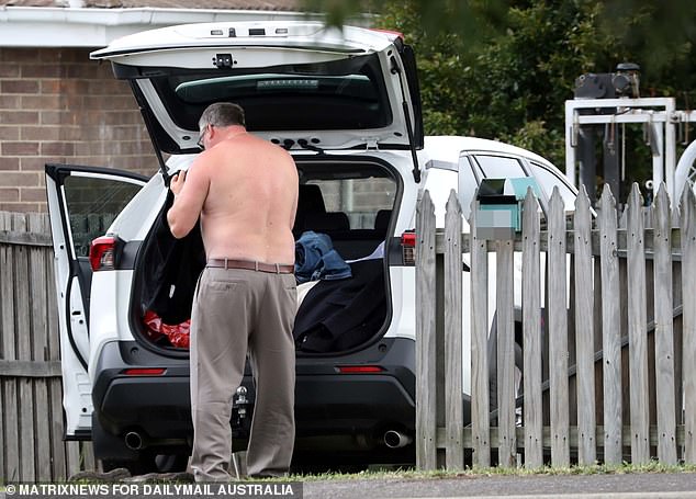 Hallam changes from his courtroom coup in the front yard of a fisherman friend's house.