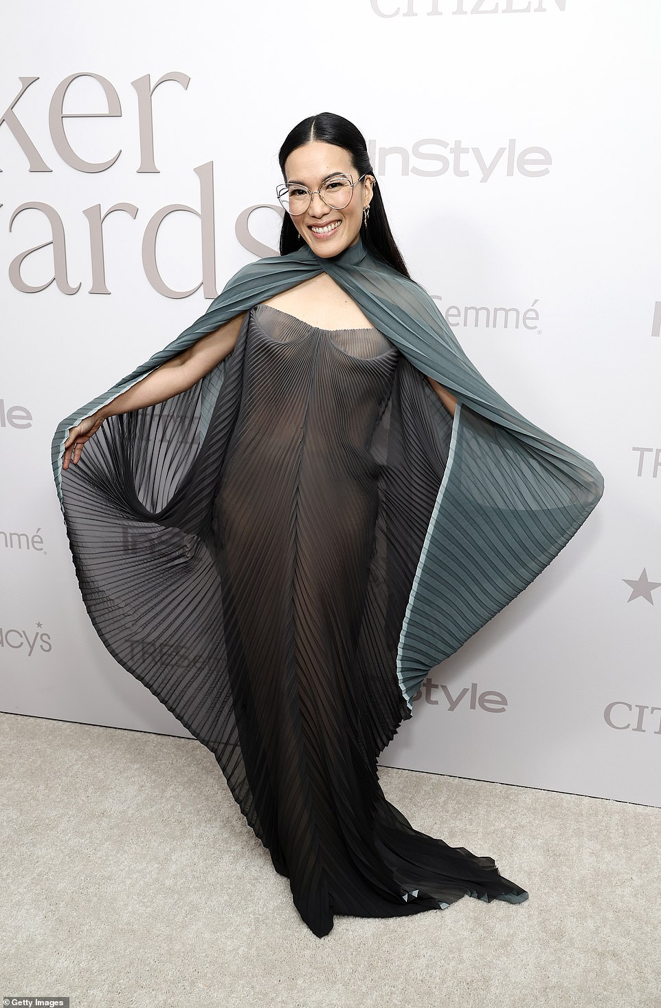 Ali Wong Radiates Pure Elegance in a Flowy Two-Tone Dress with an Attached Cape