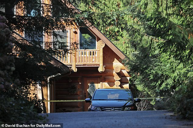 The home on Lake Alice Road is seen with police tape Thursday after Monday's mass shooting.