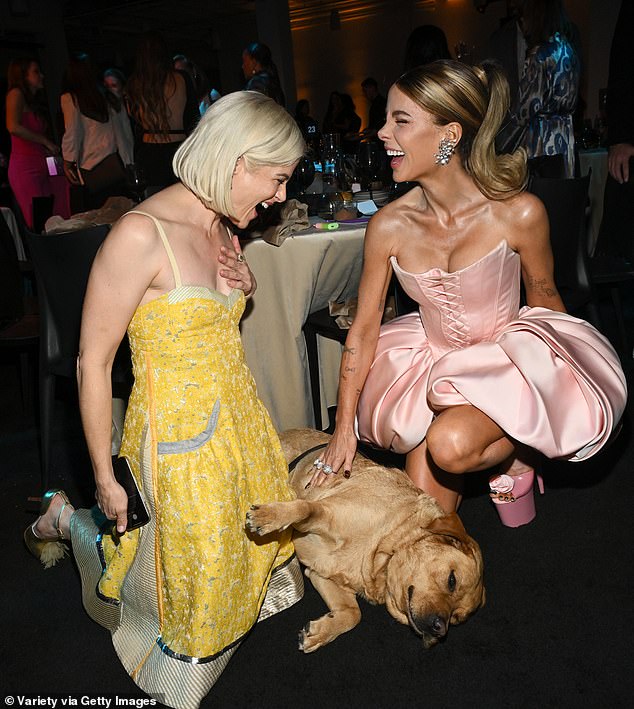 Taking a seat at the event, he joined Selma Blair and the pair laughed while petting a dog.