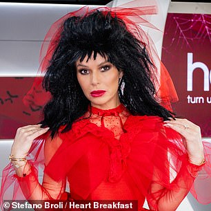 Amanda dressed as the character Lydia, with a spectacular black wig and a red tulle dress.