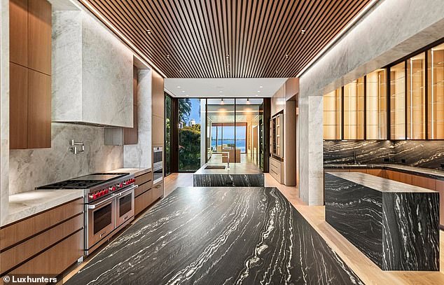 The kitchen, complete with luxurious marble surfaces and sleek appliances.