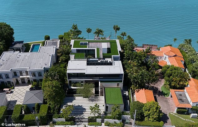 A panoramic view of the sprawling mansion (center) that features a rooftop terrace