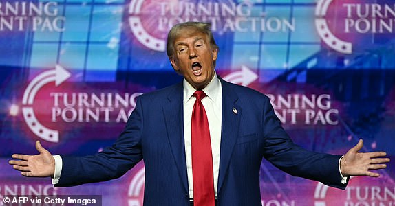 TOPSHOT - Former US President and Republican presidential candidate Donald Trump gestures as he arrives to speak during a Turning Point Action 'United for Change' campaign rally in Las Vegas, Nevada, on October 24, 2024. (Photo by Patrick T. Fallon / AFP) (Photo by PATRICK T. FALLON/AFP via Getty Images)