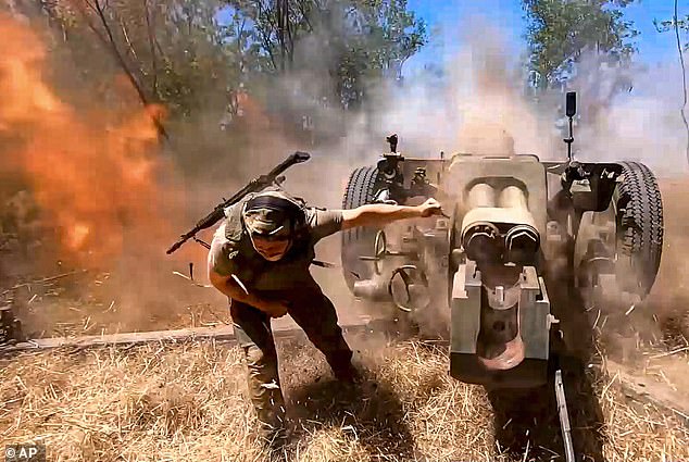 A Russian soldier fires a D-30 howitzer at Ukrainian positions in an undisclosed location in Ukraine.