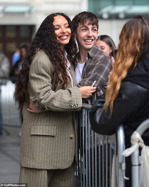 The singer seemed more than happy to pose and talk to fans outside, sign photos and pose for selfies.