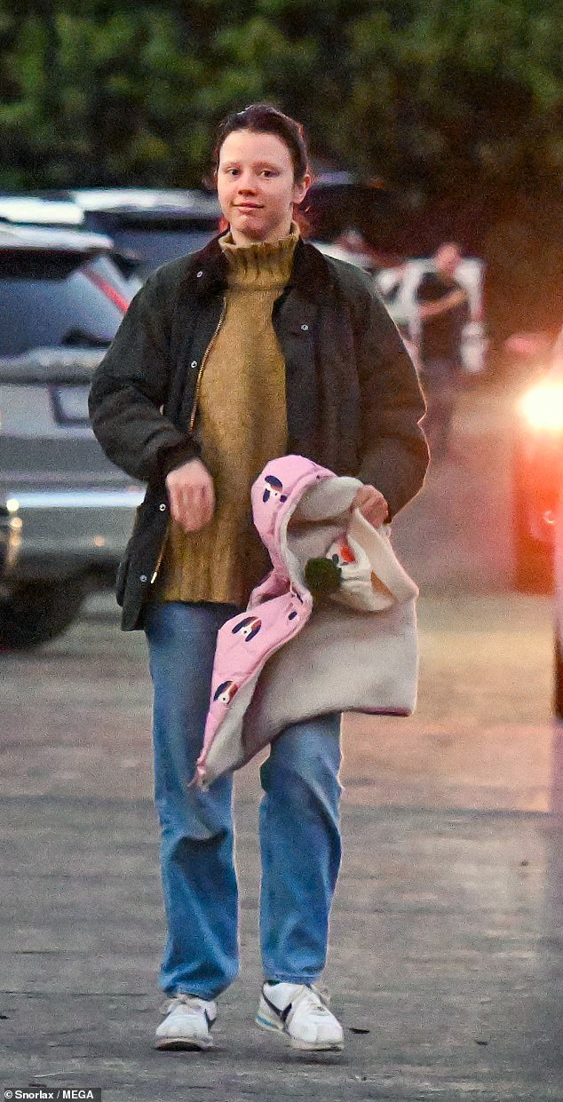 For her relaxed outing, the MaXXXine star dressed casually in a beige turtleneck, a black jacket, light-wash jeans, and white sneakers.