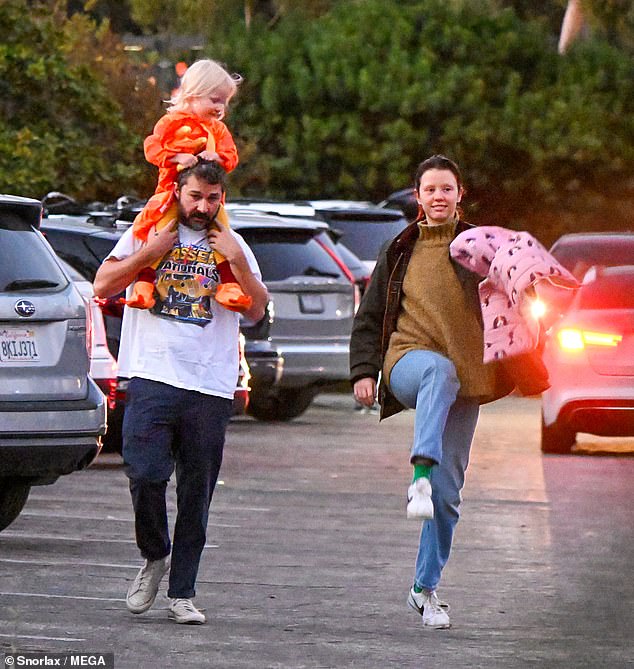 The 38-year-old actor carried his little girl on his shoulders while Goth, 31, walked next to him and carried his two-year-old daughter's pink jacket.