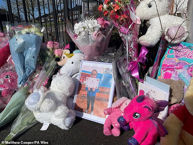 A photograph of Shay holding a certificate was placed among the floral and tender tributes outside her home in Rowley Regis.