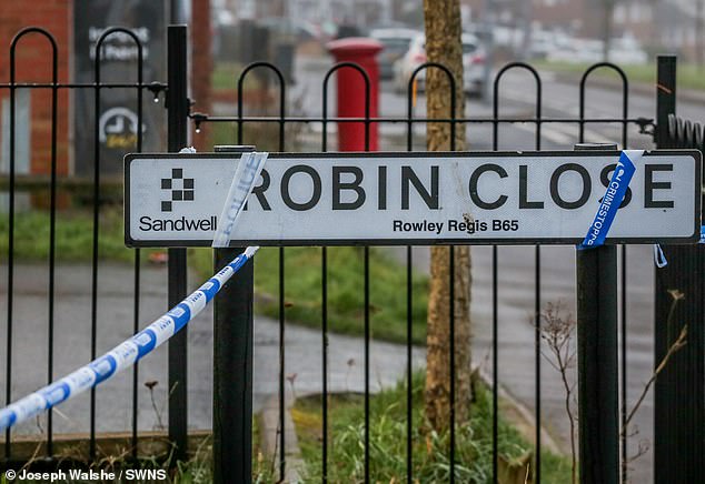 Pictured: Police cordon off around the Robin Close sign after the discovery of the 10-year-old boy's body.