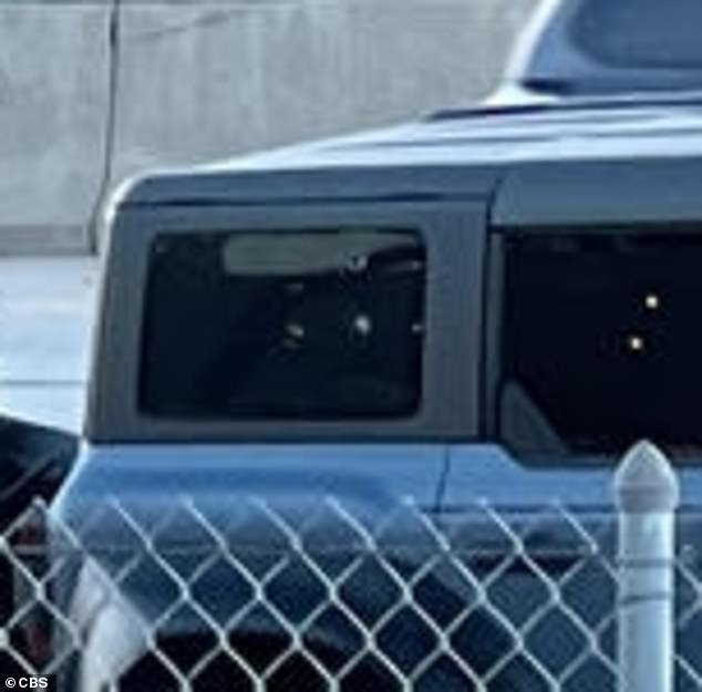 The victims' blue Ford Bronco appeared to have suffered significant gunshot damage.