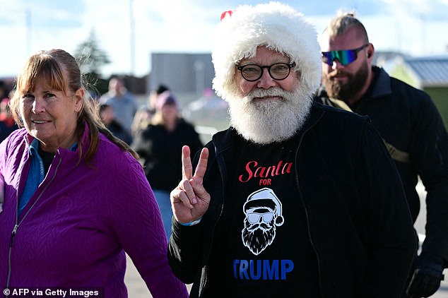 Making a list: Trump supporters lined up to greet Trump on a day when Kamala Harris accused him of making an 'enemies list' for planned retaliation.