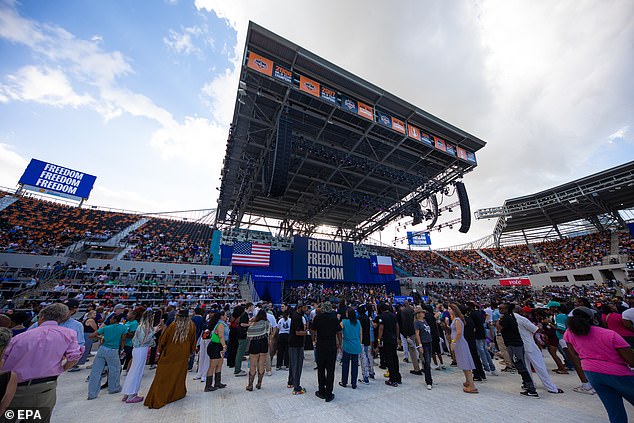 Supporters wait inside Shell Energy Stadium in Houston under signs that