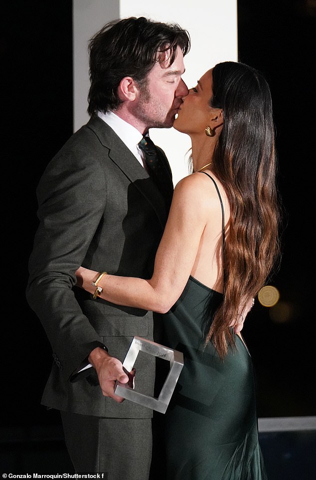 The couple celebrated Olivia's recognition with a kiss.