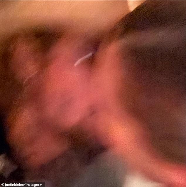 Bieber included a blurry snapshot showing him kissing his wife of six years.