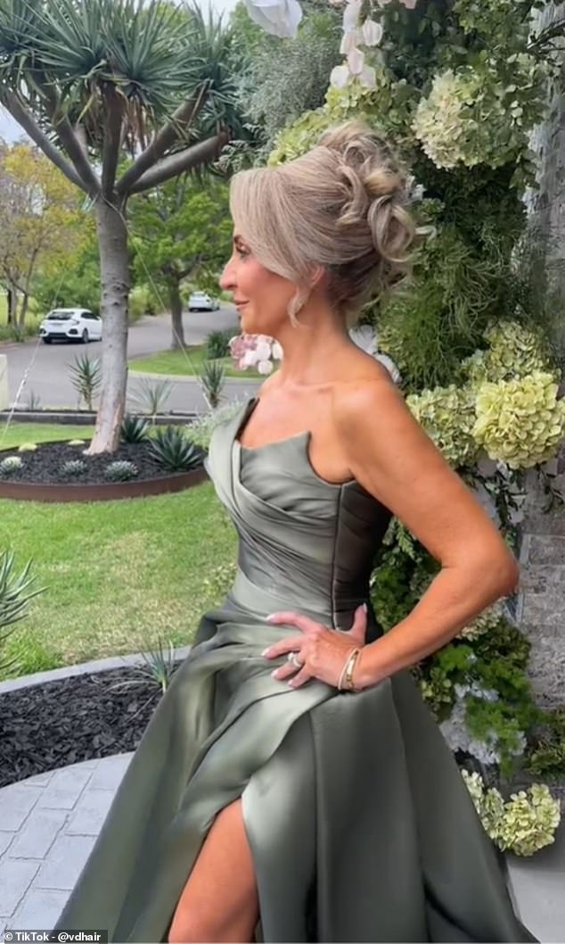 The mother of the bride can be seen strutting confidently on her front lawn to show off the stunning olive green gown, custom-made by couture designer Georgina Marie.