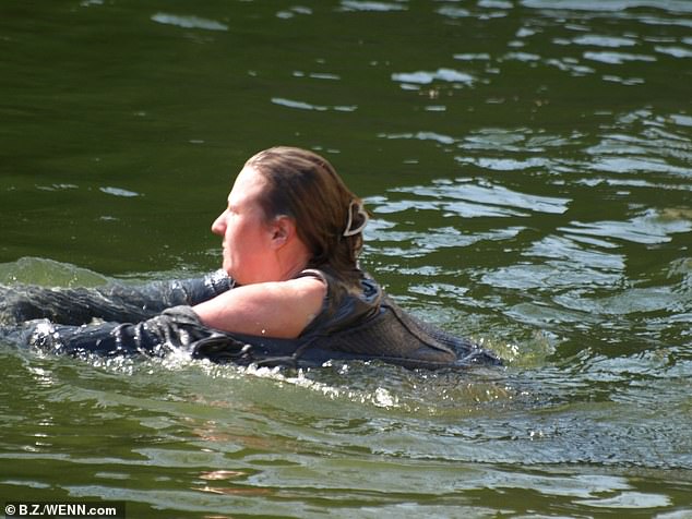 To the surprise of onlookers, a 32-year-old woman was now inside the exhibit and swimming toward the polar bears.