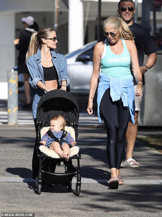 Lucy was seen pushing her daughter Robbie and chatting to her new mother-in-law Julie.