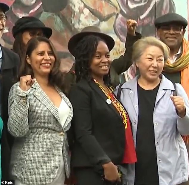 Fife, center, celebrates the passage of his legislation to defund the police in Oakland in 2021.