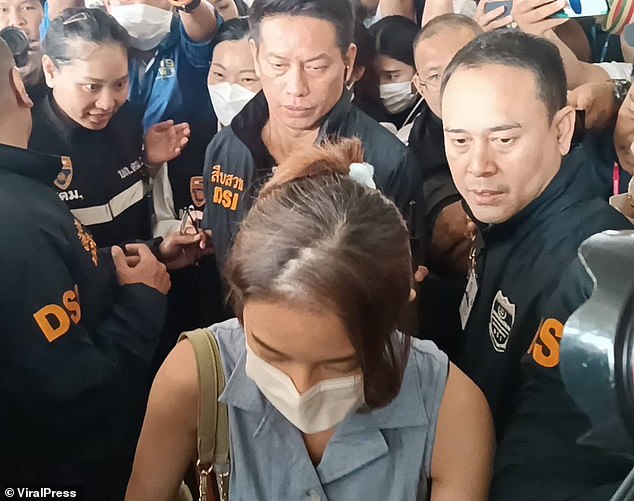 Footage shows Natthamon returning to Bangkok yesterday flanked by members of the country's Special Investigation Department.