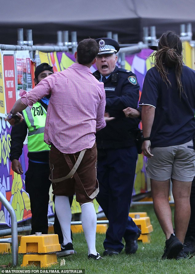 A police officer gives marching orders to a reveler.