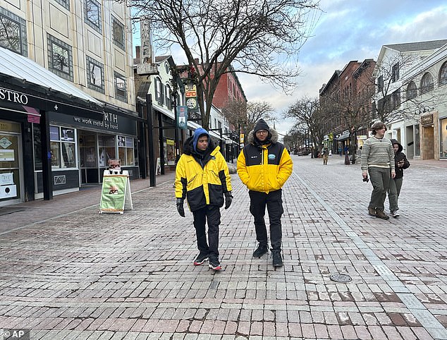 Two security guards walk through Church Street Marketplace in Burlington, which has beefed up security amid fears of drug activity, gun violence and retail theft.