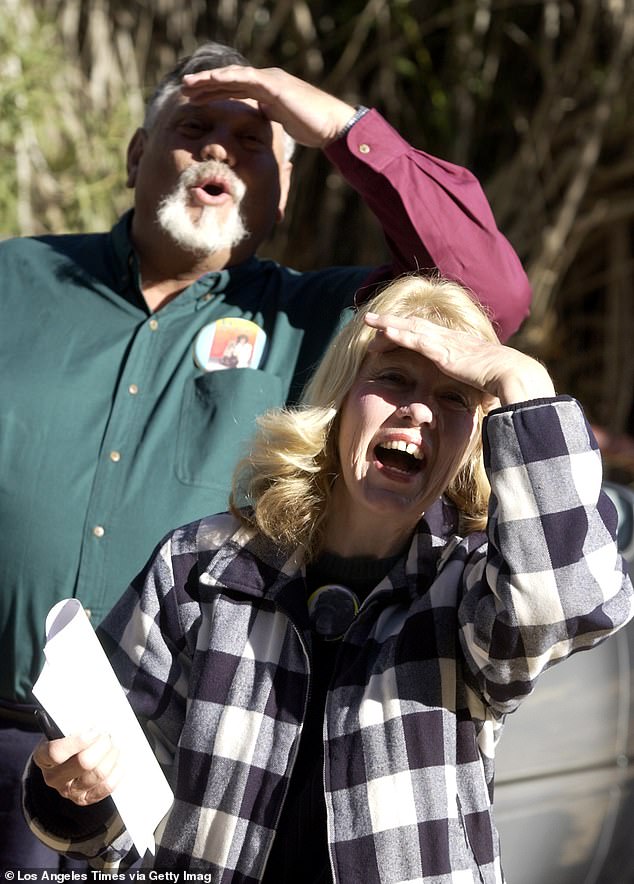 St. James Davis, left, and his wife La Donna Davis call Moe as they visit their adopted chimpanzee after he was removed from their West Covina home.