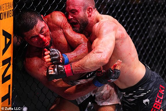 ABU DHABI, UNITED ARAB EMIRATES – OCTOBER 26: (RL) Mateusz Rebecki of Poland hits Myktybek Orolbai of Kyrgyzstan in a 160-pound fixed weight bout during the UFC 308 event at Etihad Arena on October 26, 2024 in Abu Dhabi , United Arab Emirates. (Photo by Chris Unger/Zuffa LLC)