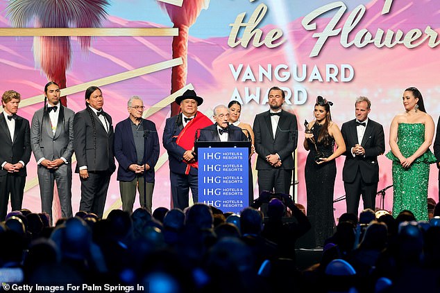 From left to right: Jesse Plemons, Tatanka Means, William Belleau, Robert De Niro, Yancey Red Corn, Martin Scorsese, Leonardo DiCaprio, Lulu Goodfox, Bradley Thomas, Lily Gladstone and Talee Redcorn accept the Vanguard Award for Killers of the Flower Moon during the Vanguard Awards on January 4 in Palm Springs, California