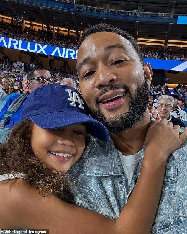 In another snap, his daughter sweetly wrapped her arms around her father as the couple posed together for a quick selfie while sitting in the stands.