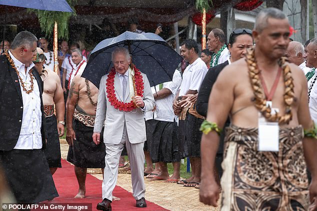 The King and Queen later took shelter under umbrellas as they boarded their plane home in pouring rain.