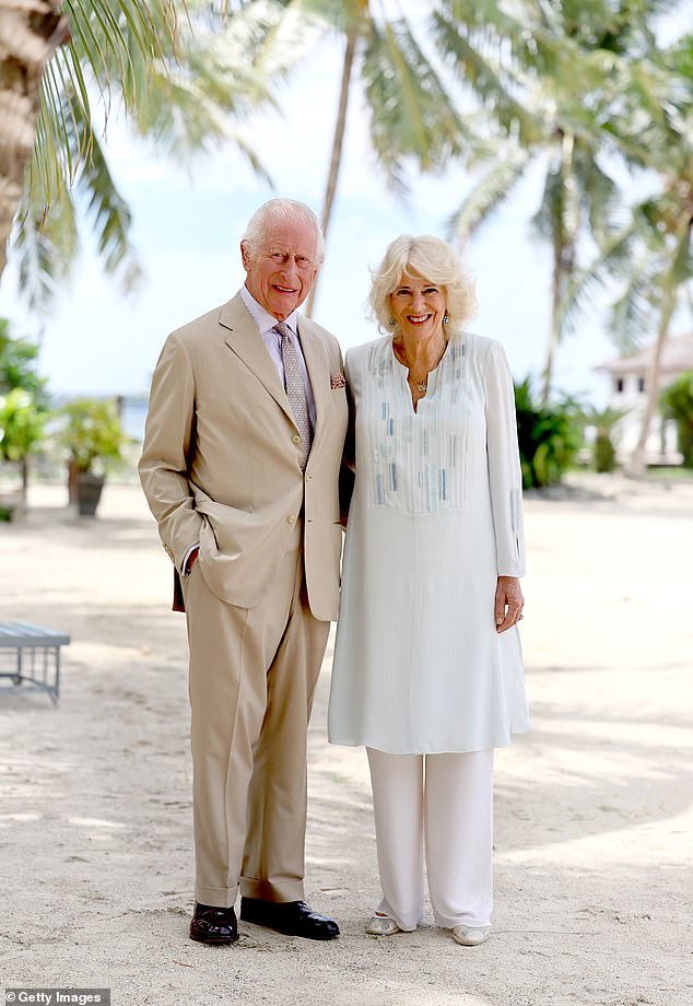 King Charles III and Queen Camilla smile during a visit to a beach in Apia, Samoa