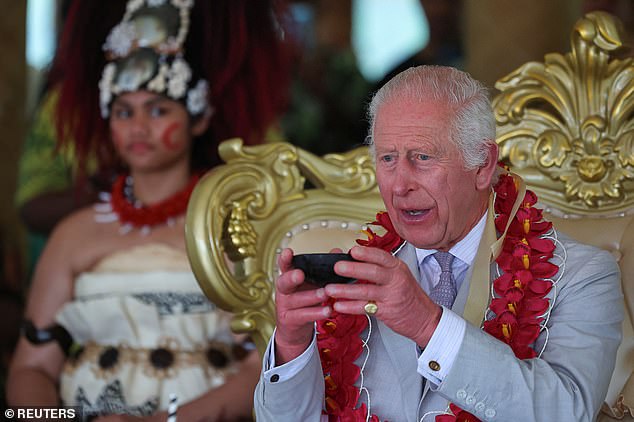 King Charles holds a bowl during a ceremony in Siumu Village, Samoa, on October 26.