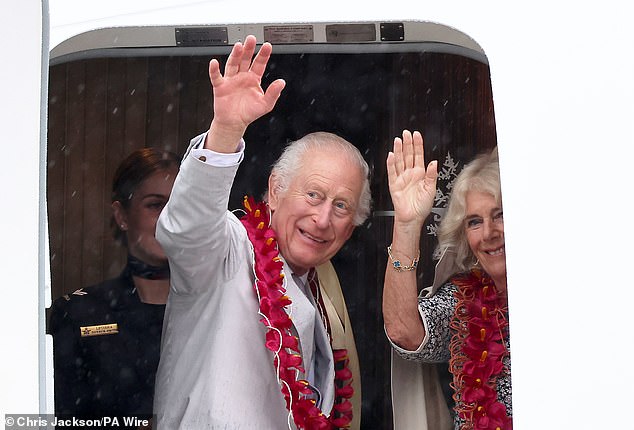 King Charles III and Queen Camilla wave as they board a Royal Australian Air Force plane before departing from Faleolo International Airport in Samoa.