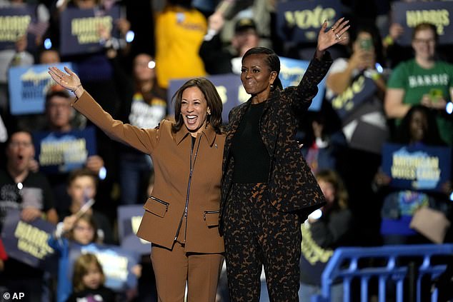 Harris with Obama at the Wings Event Center. The former first lady questioned why Harris is being held to a higher standard than Trump and praised her for being ready to meet the moment.