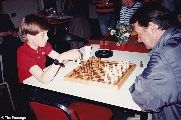 William, then 11 years old, can be seen handing out Christmas presents, playing a game of chess (pictured) and listening intently as his mother talks to those at the shelter.