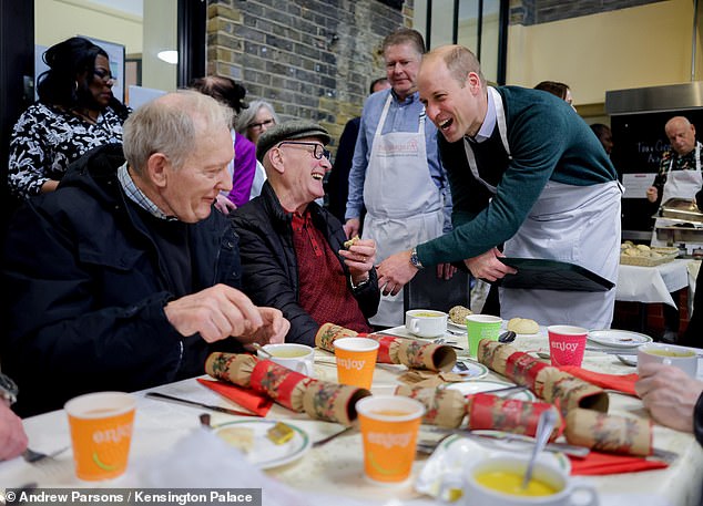 Prince William is pictured offering help while in The Passage at Kensington Palace.