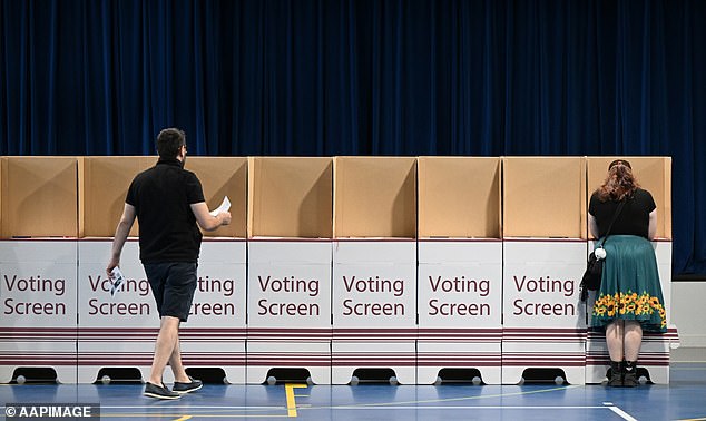 Queensland voters seen at a polling booth at Kallangur State School in Brisbane on Saturday