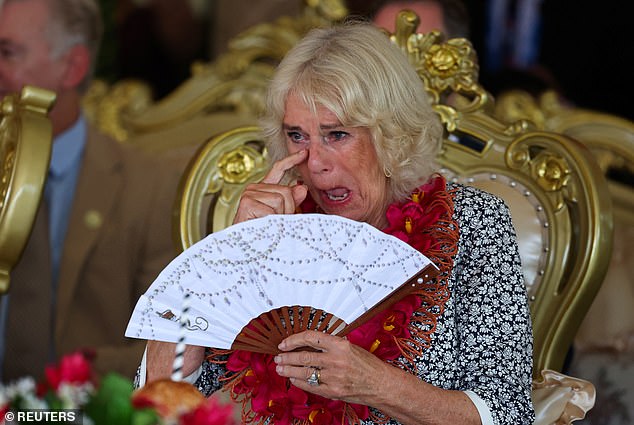 Queen Camilla holds a fan during the farewell ceremony on October 26.