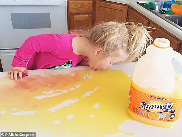 Delicious? The photos reveal what children do when left alone, including one girl who poured half a container of Sunny D on the table and naturally proceeded to lick it up.