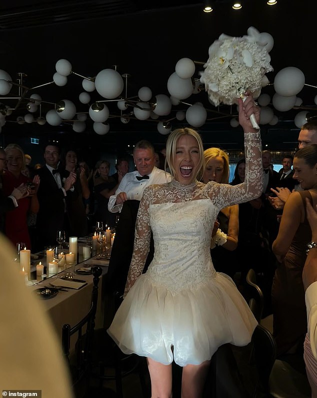 For the reception, the blushing bride opted for a less elaborate gown, but maintained an air of sophistication with lace sleeves and a short satin skirt.