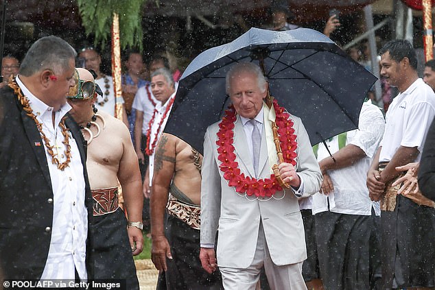 Charles was conferred with another honorary title, To'aiga-o-Tumua, and he and the Queen were presented with garlands as they arrived in the pouring rain.