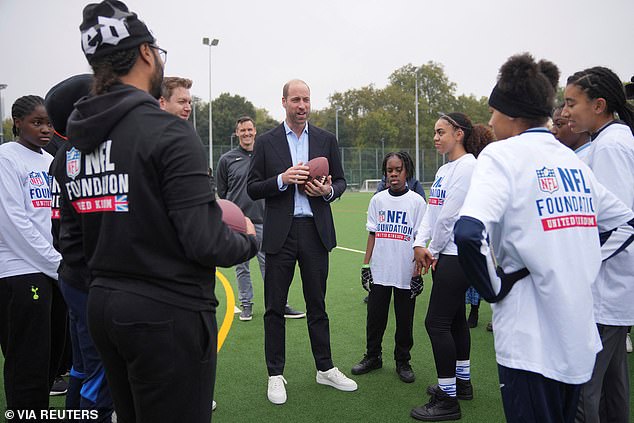 William at the NFL Foundation, dressed in a fitted jacket, shirt and chinos, with a pair of stylish white sneakers.