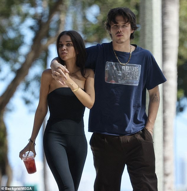 Jackie took a sip of an ice-cold drink and she and Cruz strolled around Miami.