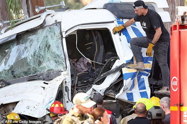 Israeli police inspect the truck driver's body at the scene of a car-ramming attack in Ramat Hasharon, north of Tel Aviv, on October 27, 2024.