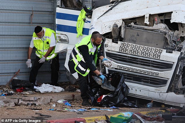 Israeli emergency services clear the scene after a driver plowed his truck into a crowd of people at a bus stop in Ramat Hasharon, north of Tel Aviv, on October 27, 2024.