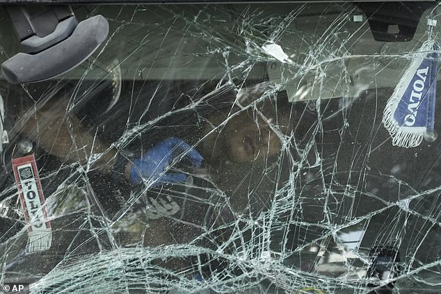 An Israeli police officer inspects the interior of the cabin of a truck that crashed into a bus stop near the headquarters of the Israeli spy agency Mossad, injuring dozens of people, according to the Israeli rescue service Magen David Adom nearby. from Tel Aviv, Israel.