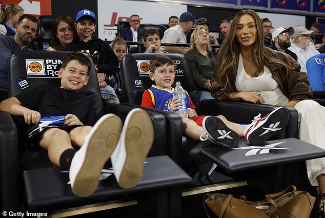 Nadia was every inch the doting mother as the kids got into the spirit wearing basketball gear and clapping.