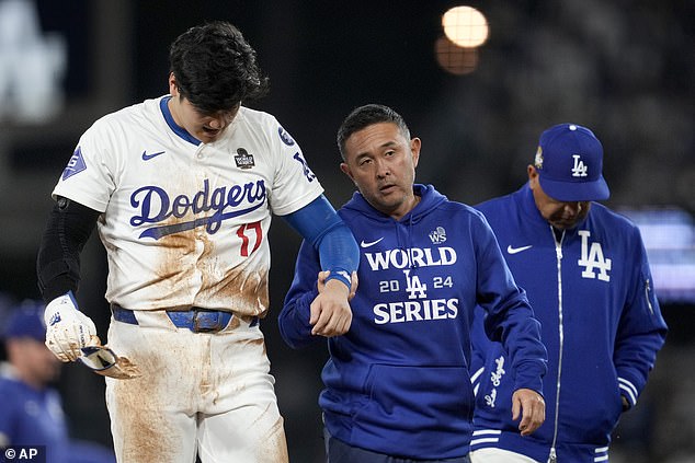 Ohtani Ohtani is helped off the field after being injured during the seventh inning of Game 2.