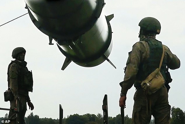 Russian soldiers load Iskander-M short-range ballistic missile launchers into a firing position as part of a Russian military exercise aimed at training troops in the use of tactical nuclear weapons.